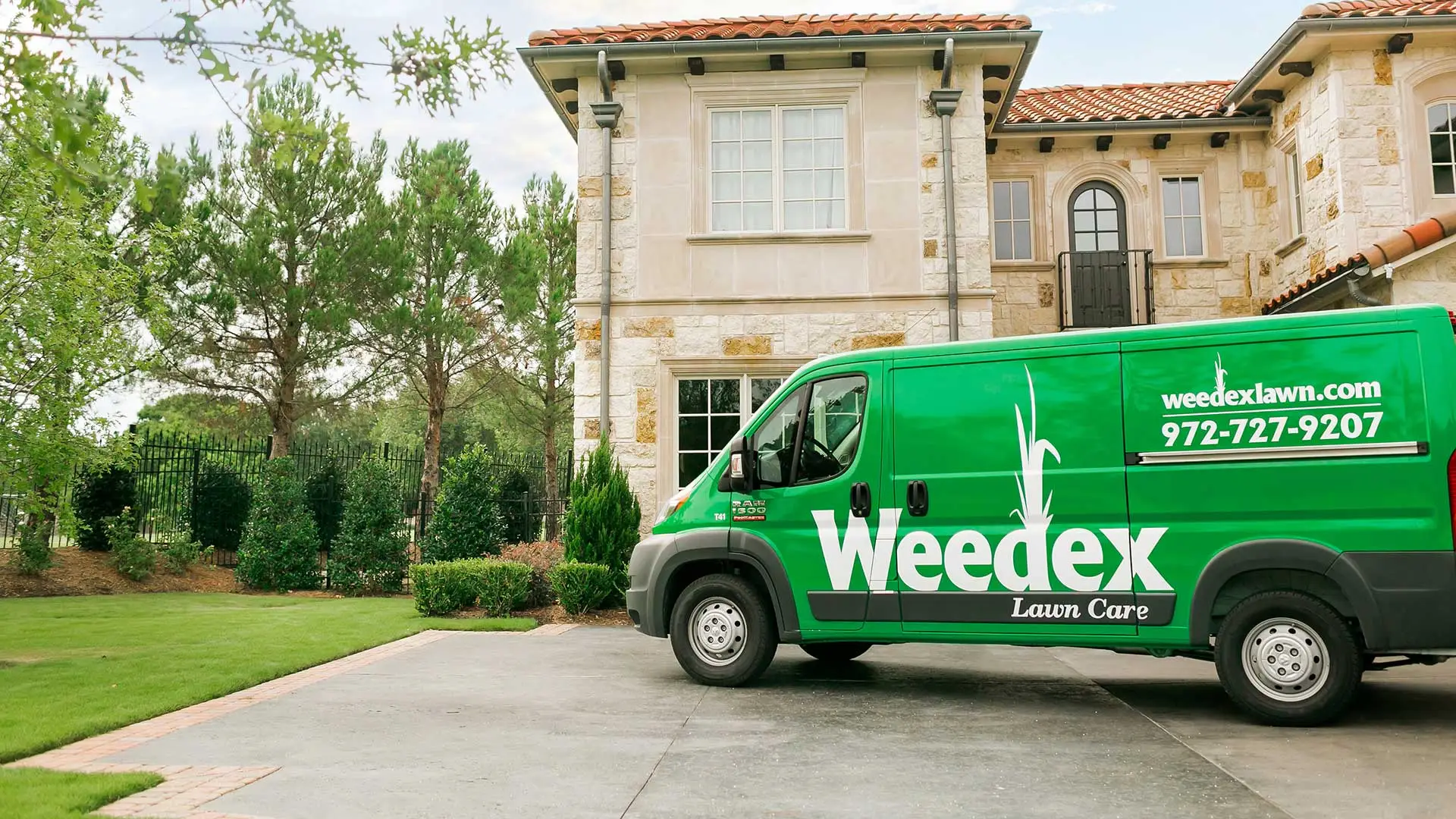 Weedex Lawn Care service vehicle in front of a home in Dallas, TX.